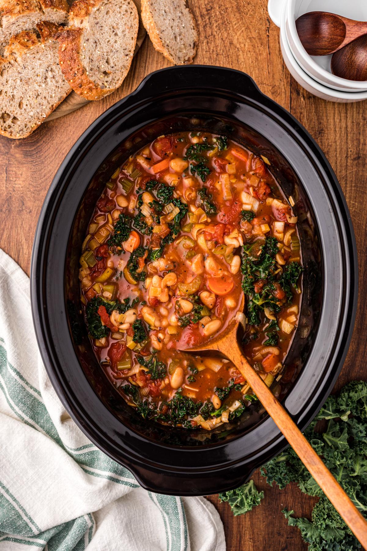 Zuppa Ribollita a cottura lenta 2 Ribollita soup in a slow cooker on a spoon.
