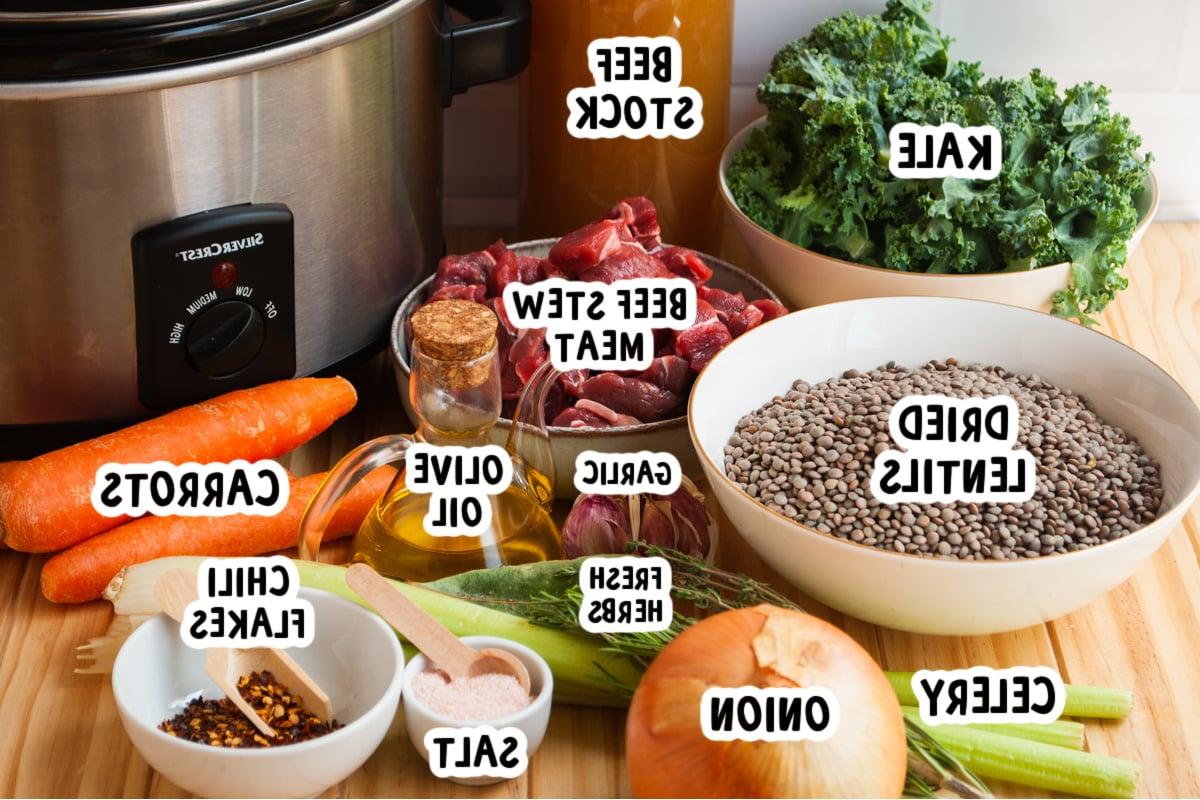 ingredients for slow cooker beef and lentil soup on a table.