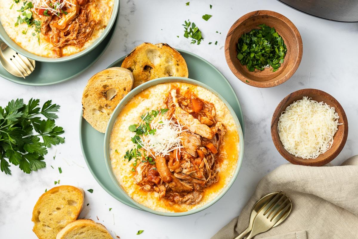 Pollo alla Marinara a Cottura Lenta {con Polenta} 7 overhead shot of chicken marinara in a bowl over polenta.