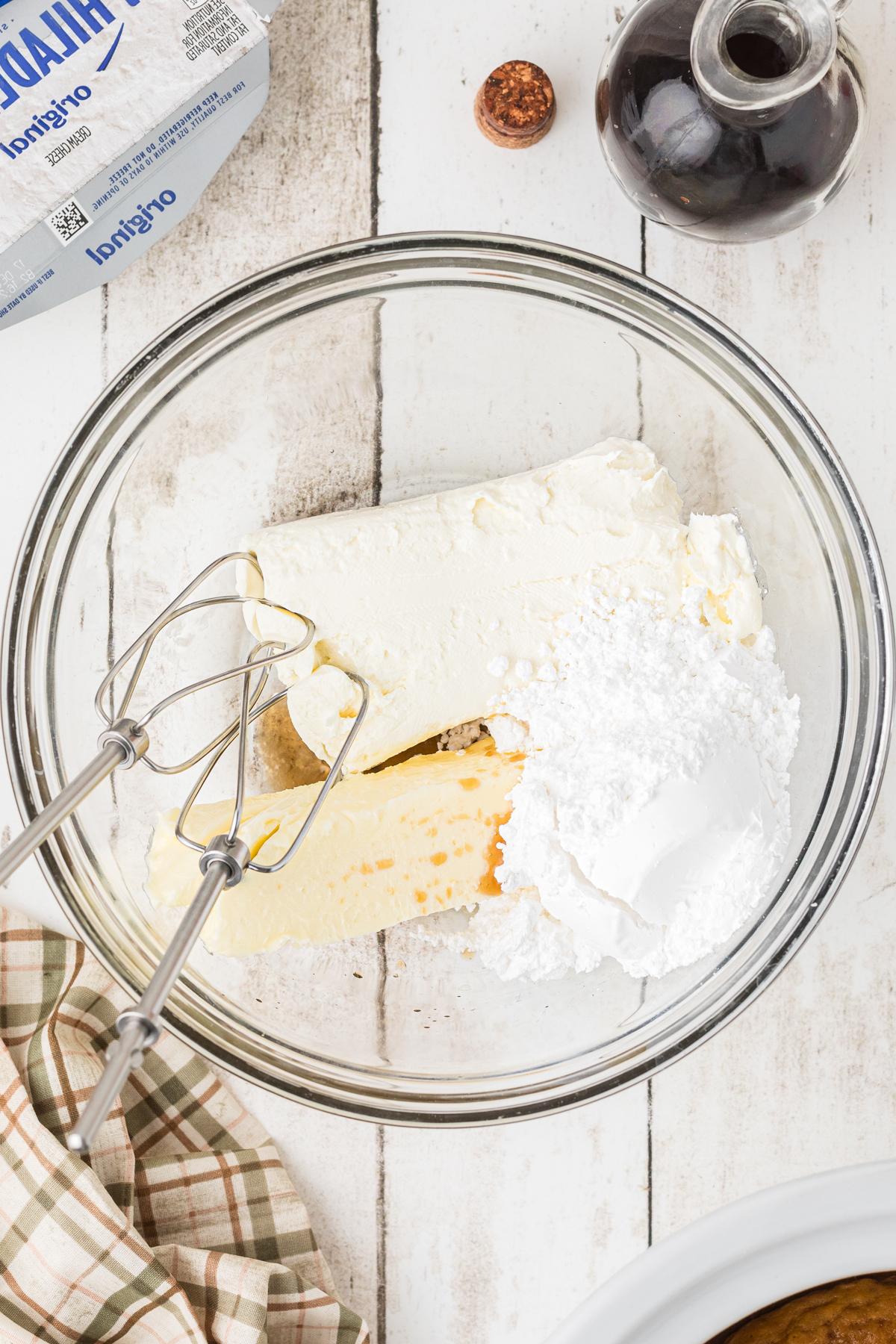 Quadrotti di Zucca Cotti Lentamente 7 Ingredienti per glassa al formaggio cremoso in una ciotola per mescolare.