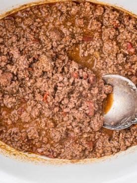 Tacos di Cervo a Cottura Lenta 8 overhead shot of venison taco meat with a spoon in it.
