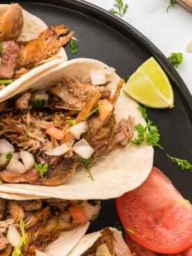 Carnitas nella Pentola a Cottura Lenta 9 close up of carnitas tacos on a plate.