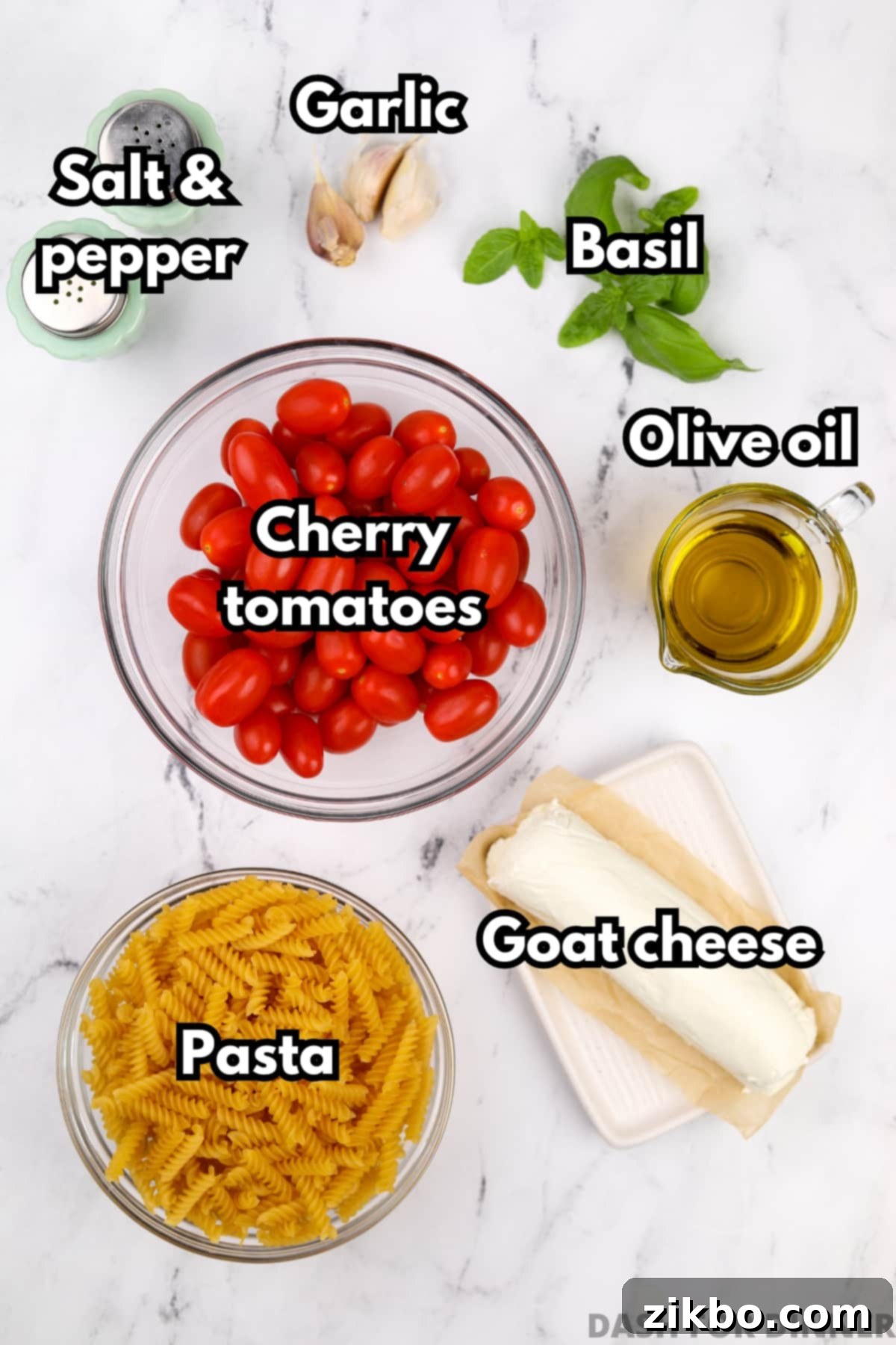 Tangy Goat Cheese Pasta Bake 3 The array of fresh ingredients laid out for making baked goat cheese pasta: cherry tomatoes, olive oil, goat cheese, pasta, and basil.