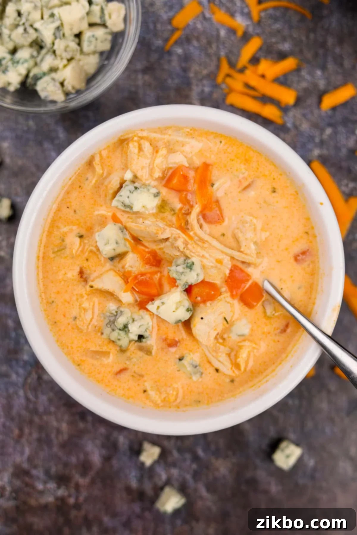 Bold Buffalo Chicken Soup 6 A beautifully presented bowl of buffalo chicken soup, generously topped with blue cheese crumbles, ready to be served.