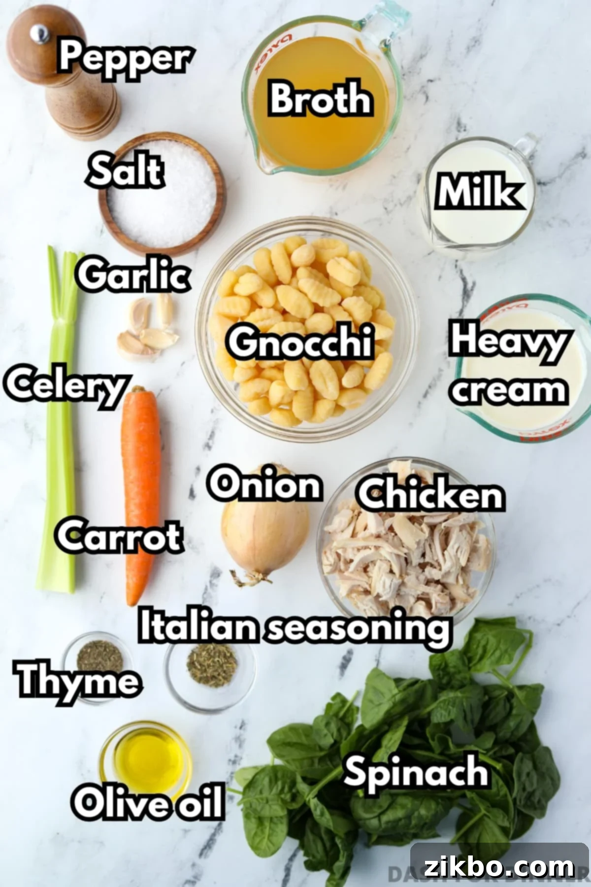 Comforting Creamy Chicken Gnocchi Soup 3 The ingredients laid out for creamy chicken and gnocchi soup, including chicken, broth, heavy cream, milk, fresh spinach, and various aromatic vegetables.