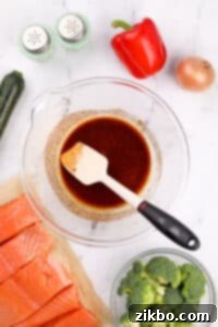 A large bowl with olive oil and seasonings mixed together.