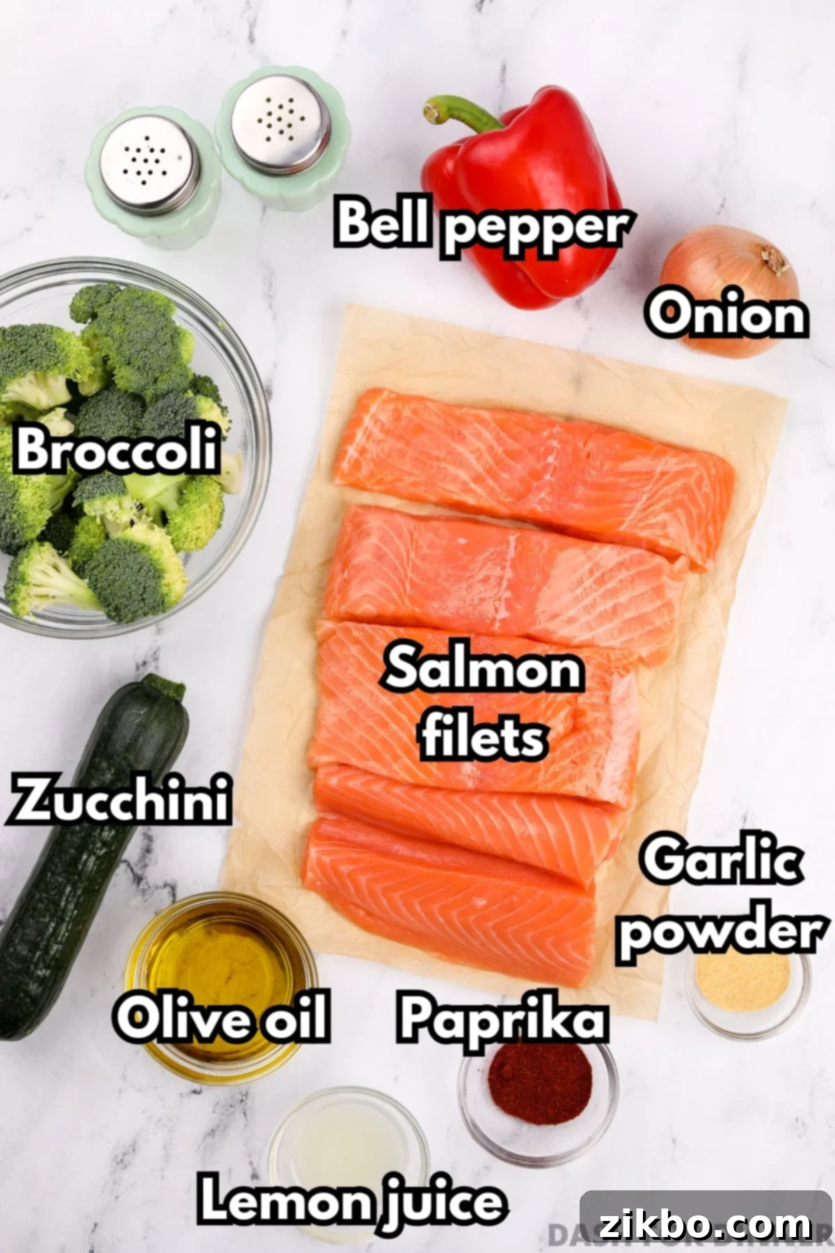Effortless Sheet Pan Salmon Feast 3 A flat lay photograph showcasing all the fresh ingredients needed for sheet pan salmon and vegetables, including raw salmon fillets, broccoli florets, sliced bell pepper, zucchini, and a bowl of olive oil with seasonings.