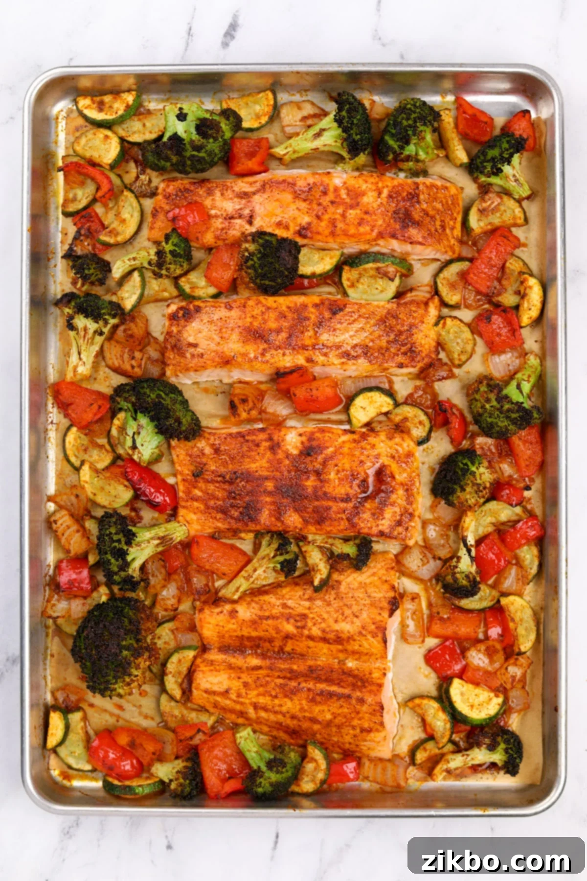 Effortless Sheet Pan Salmon Feast 9 A freshly roasted sheet pan dinner featuring golden-brown salmon fillets and perfectly tender-crisp vegetables, ready to be served.