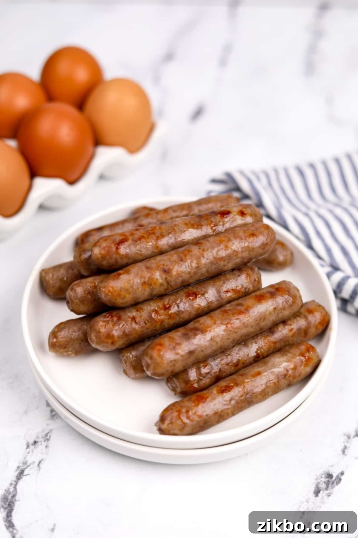 A plate of perfectly golden-brown baked breakfast sausages, ready to be served for a delicious morning meal.