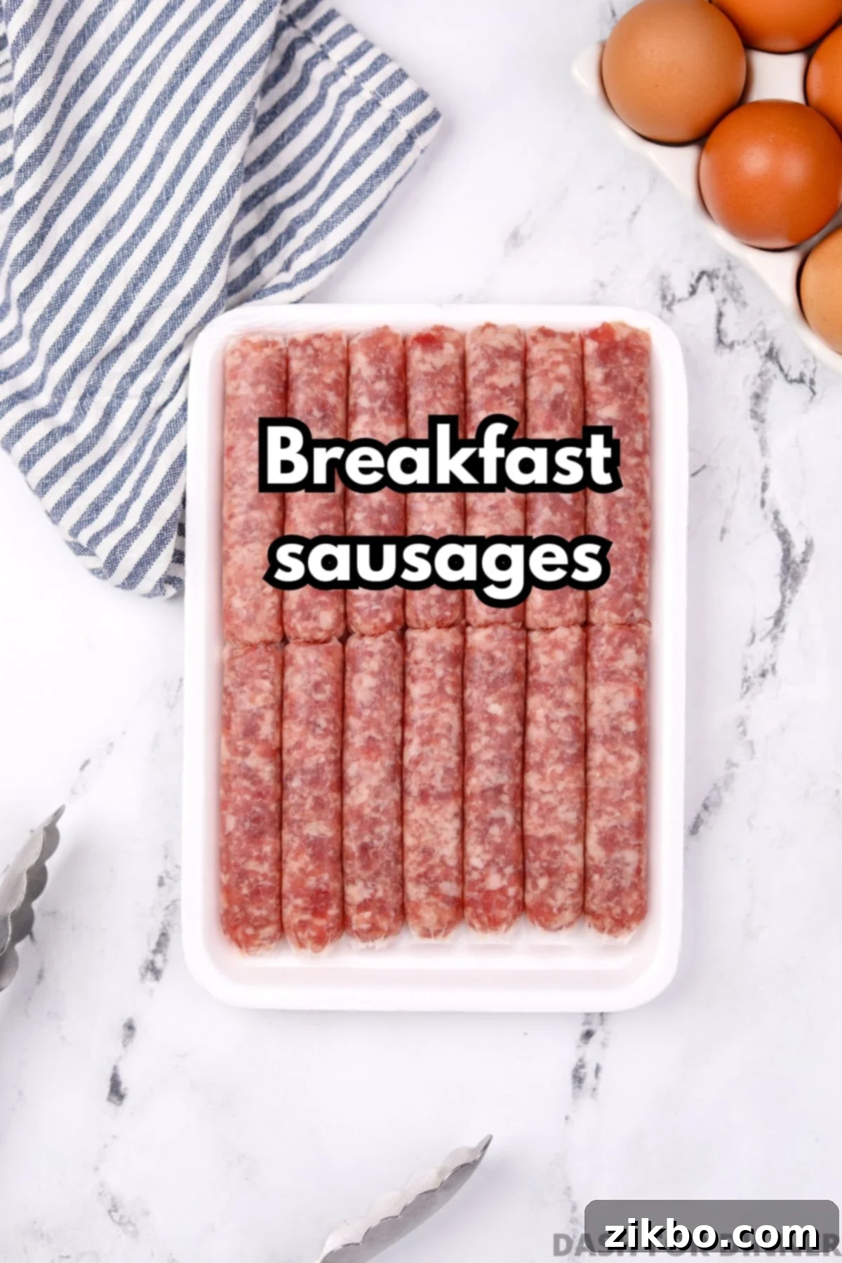 A clear image of an unopened package of uncooked breakfast sausages resting on a white marble counter, ready for preparation.