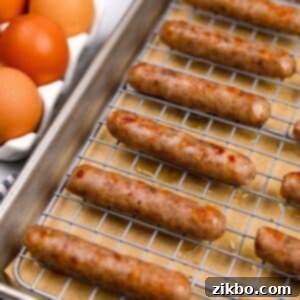 A baking sheet with cooked breakfast sausages lined up, showcasing their crispy texture.