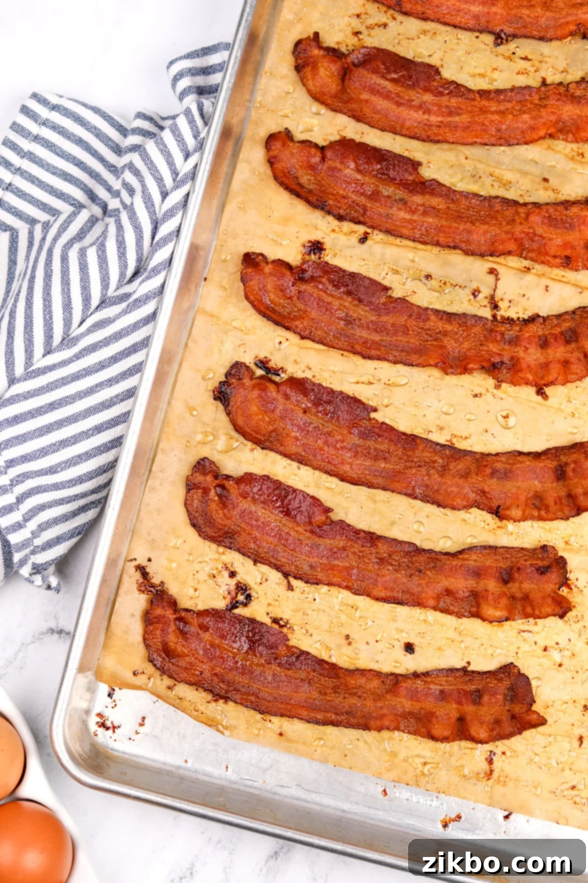 Perfectly Crispy Baked Bacon 2 A baking sheet filled with cooked crispy bacon.