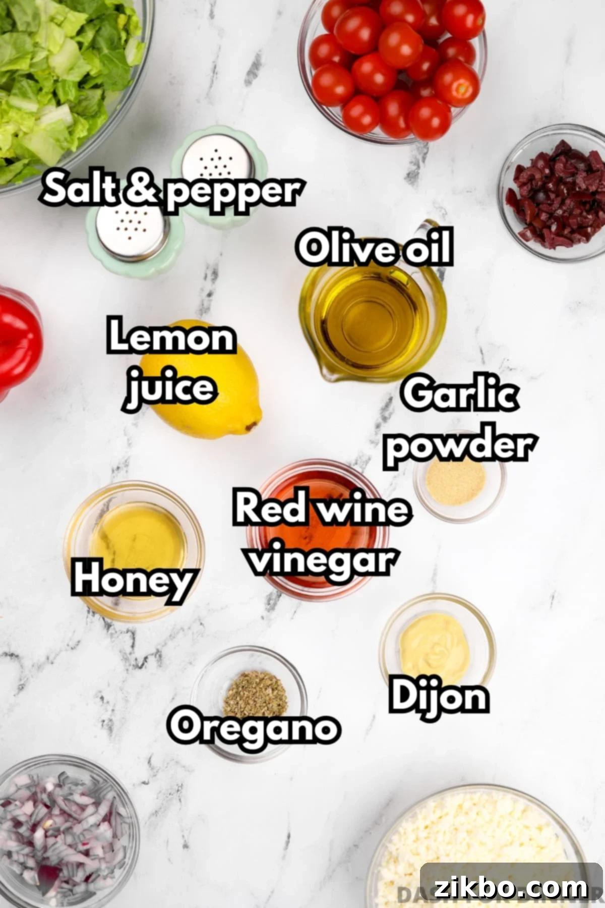 The essential ingredients needed to make homemade Greek dressing, including high-quality olive oil, red wine vinegar, honey, and dried oregano, neatly arranged.