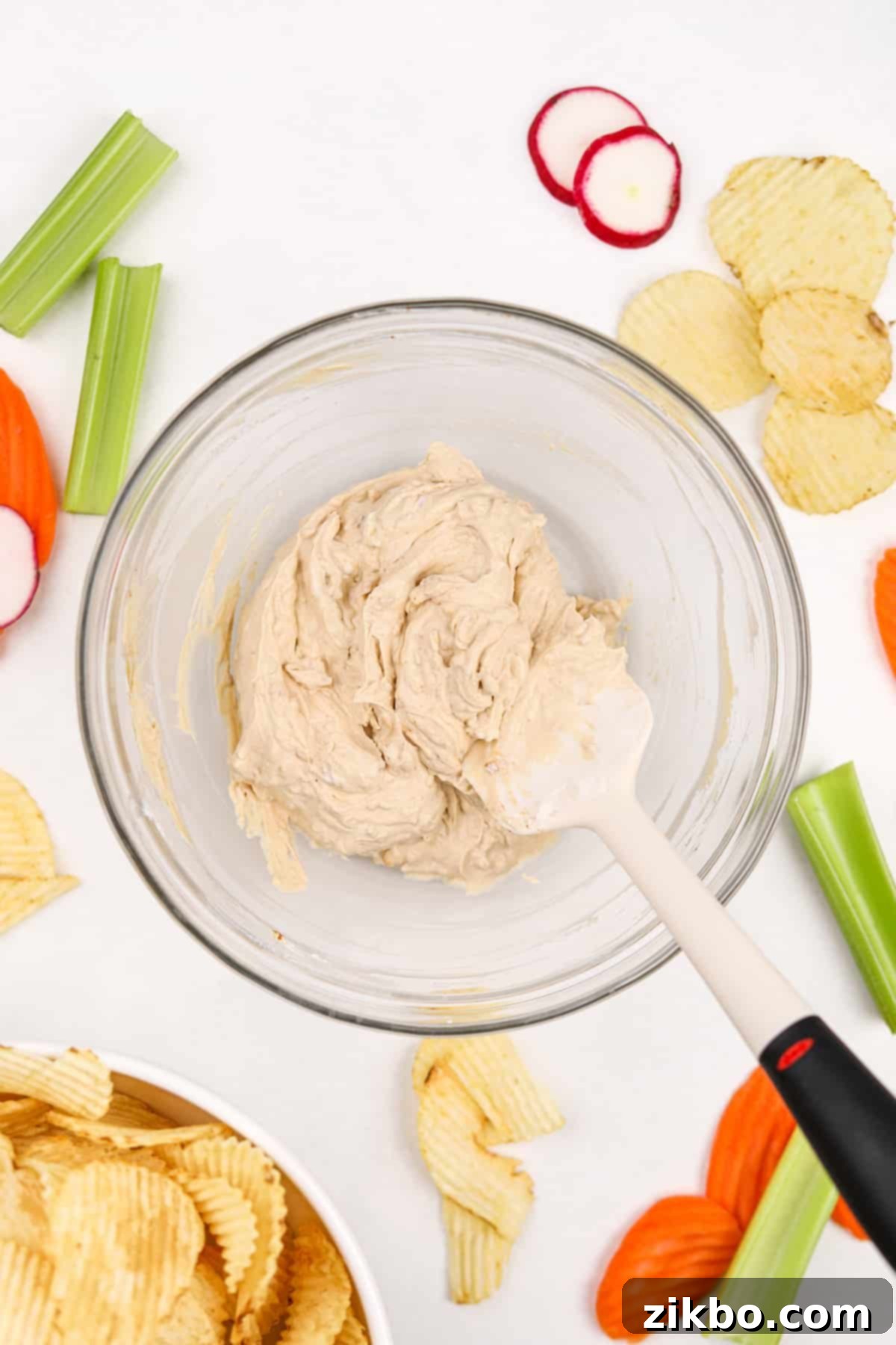 A smooth, creamy bowl of freshly mixed French onion dip, perfectly blended and ready for chilling.