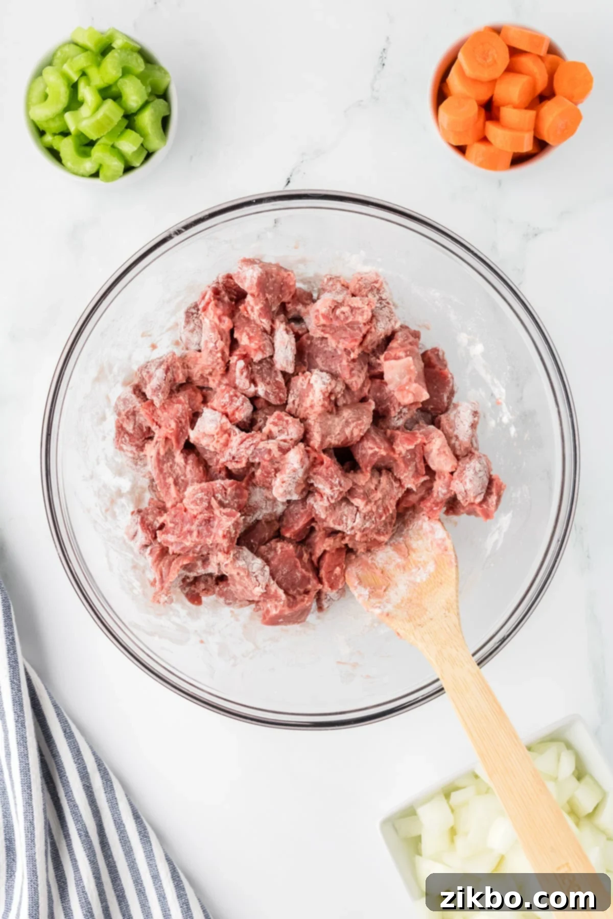 Hearty Slow Cooker Beef Stew with Tender Dumplings 4 Beef stew meat being coated with flour.