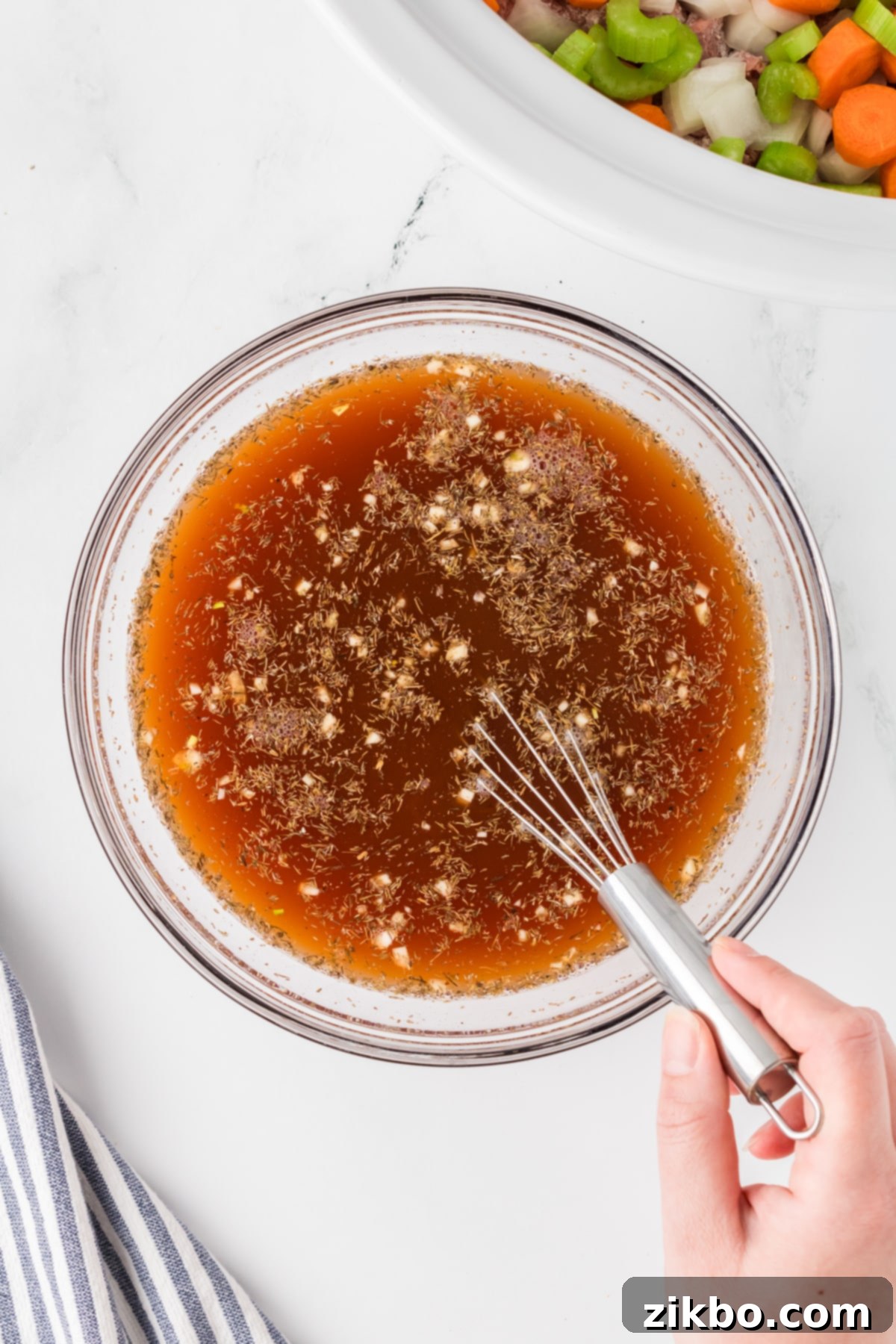 Hearty Slow Cooker Beef Stew with Tender Dumplings 6 Whisking together beef broth, seasonings, and other ingredients.