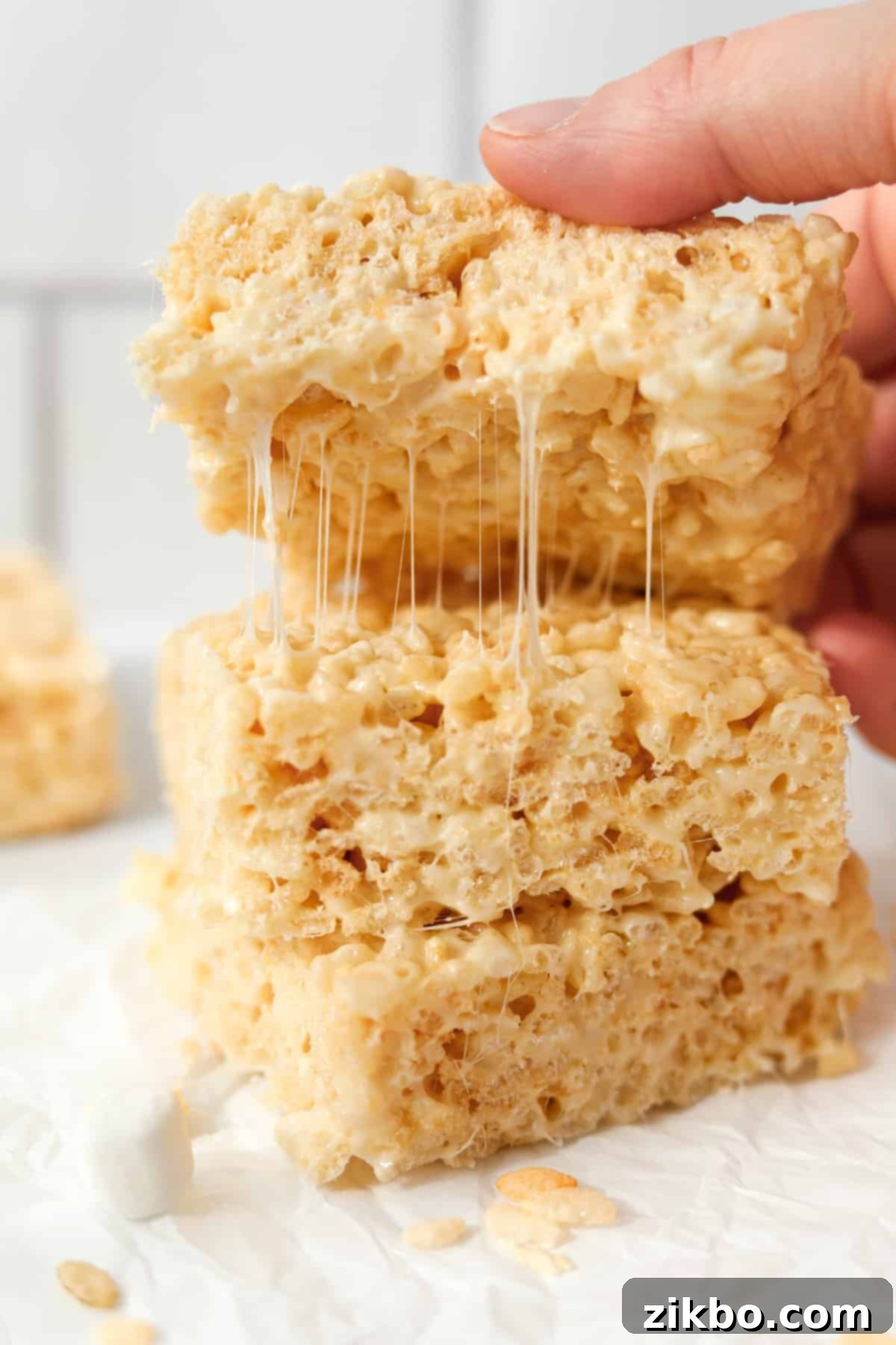 Crispy Sweet Squares 12 Another mouth-watering shot of rice krispie treats being pulled apart, showcasing the incredible gooeyness and stretch of the marshmallow, a clear sign of a perfect treat.