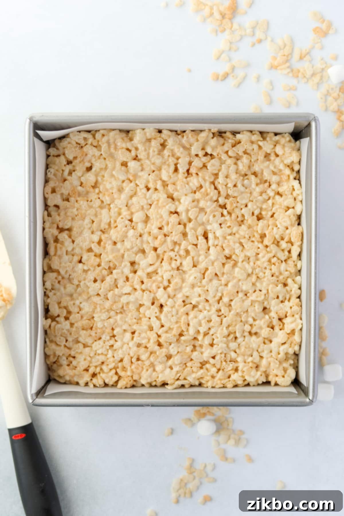 Crispy Sweet Squares 9 A square baking pan filled to the brim with freshly made, perfectly set crispy treats, ready for cooling.
