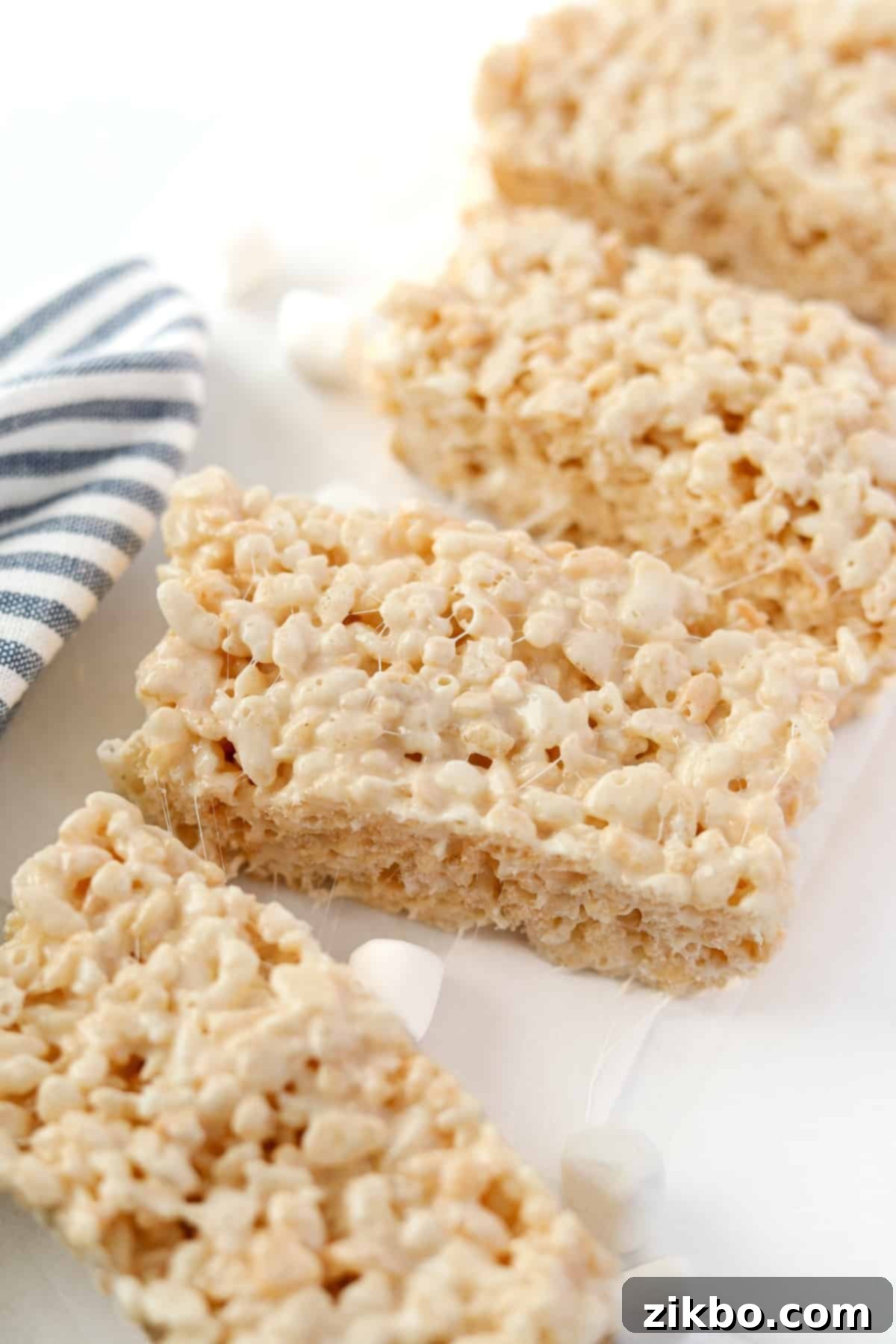 Your Little Krispie Fix 2 Four rice krispie treats on a white background.