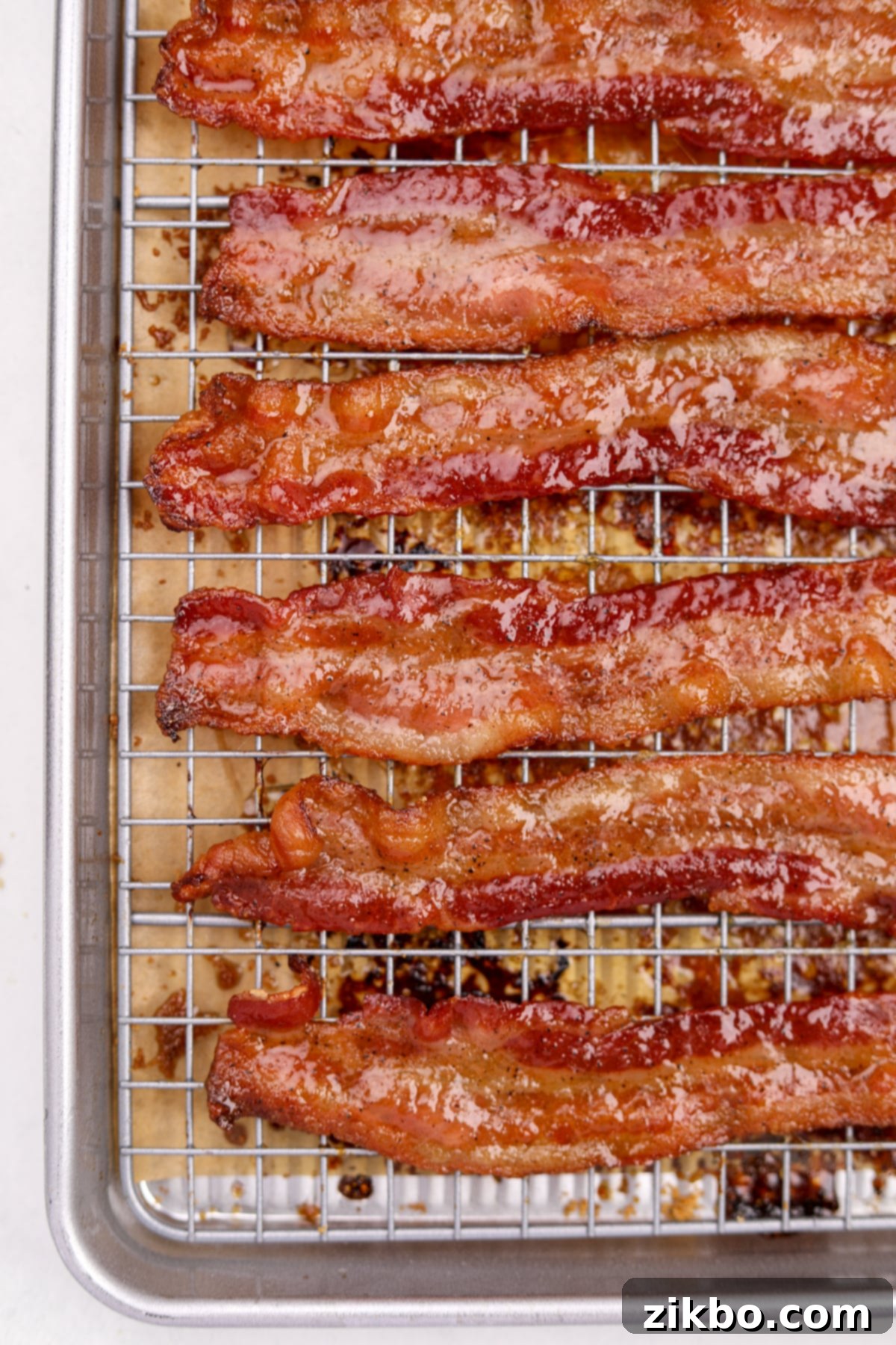 Millionaire's Bacon 11 A wire baking rack is abundantly filled with glistening, perfectly glazed candied bacon slices, ready to be enjoyed.