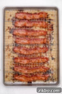 Crispy cooked bacon on a wire rack set inside of a baking sheet.