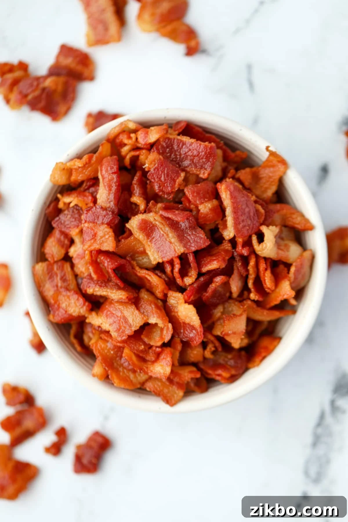 A white bowl filled with homemade bacon bits.