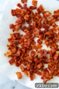 Homemade bacon bits draining on a paper towel.