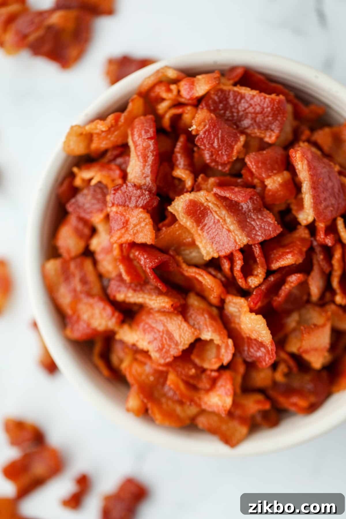 A small bowl filled with bacon bits.