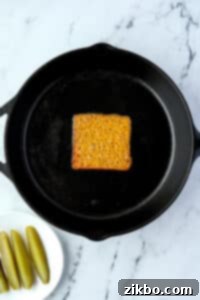 A skillet with a melted cheese slice in the middle.