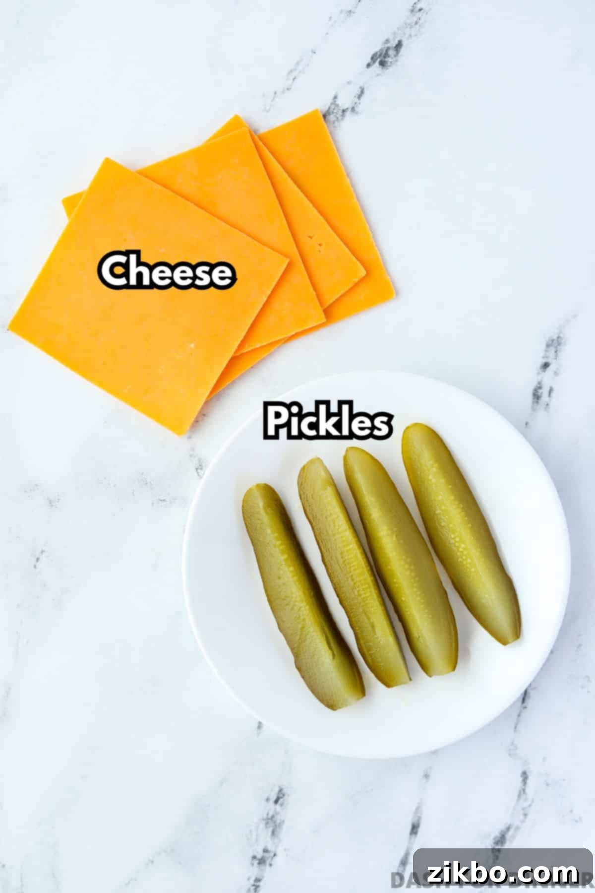 Several slices of cheese and several dill pickle spears on a marble background.