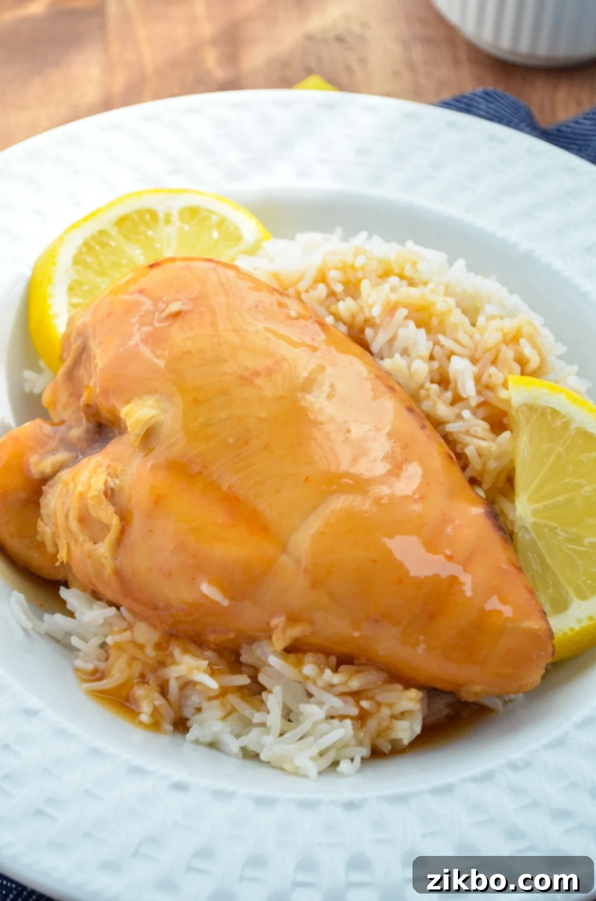 Slow cooker lemonade chicken, served on a bed of rice.