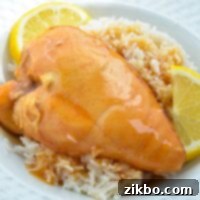 Slow cooker lemonade chicken, garnished with lemon wedges.