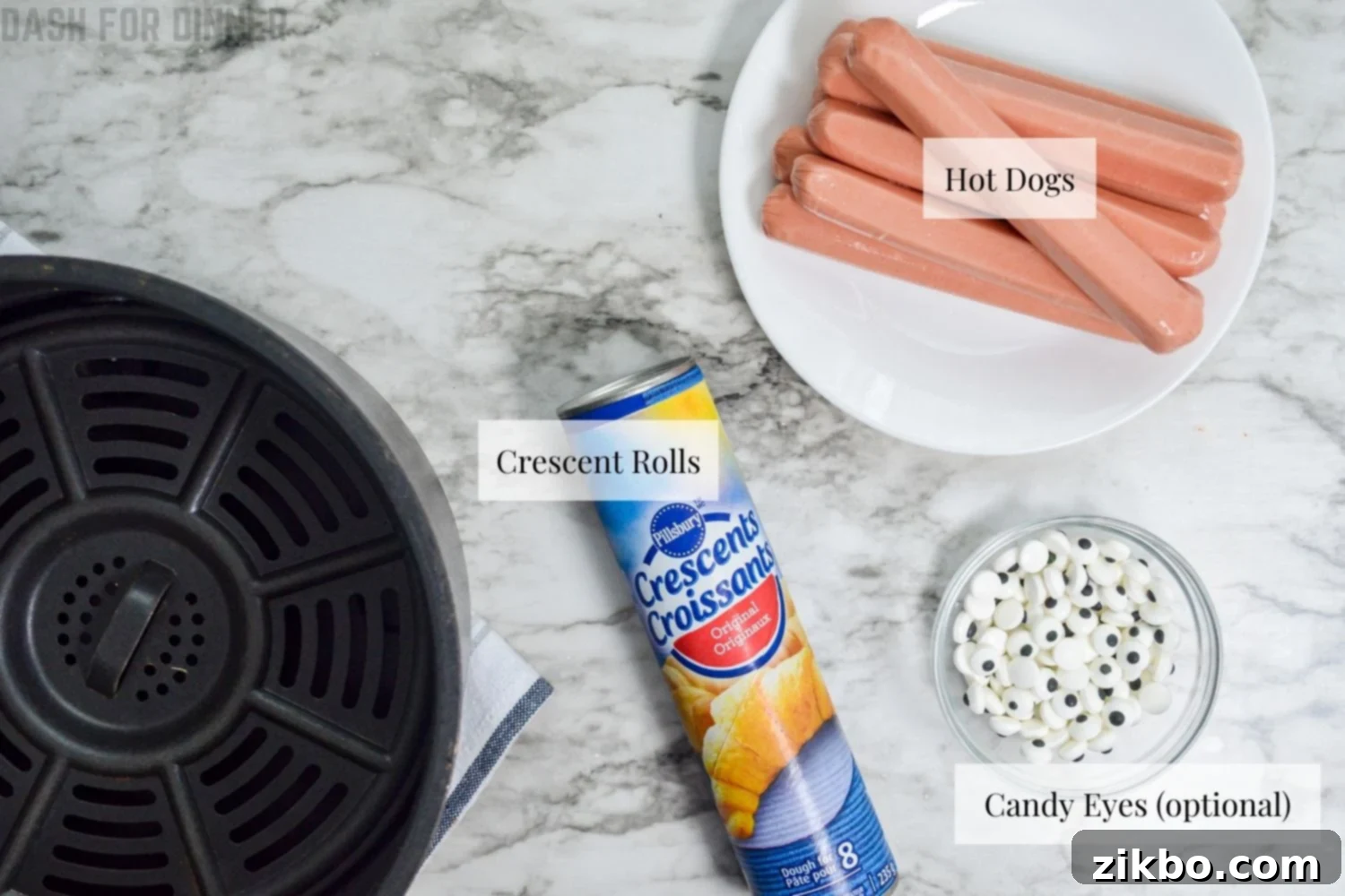 The ingredients needed to make mummy dogs in the Air Fryer: hot dogs, crescent rolls, and candy eyes.