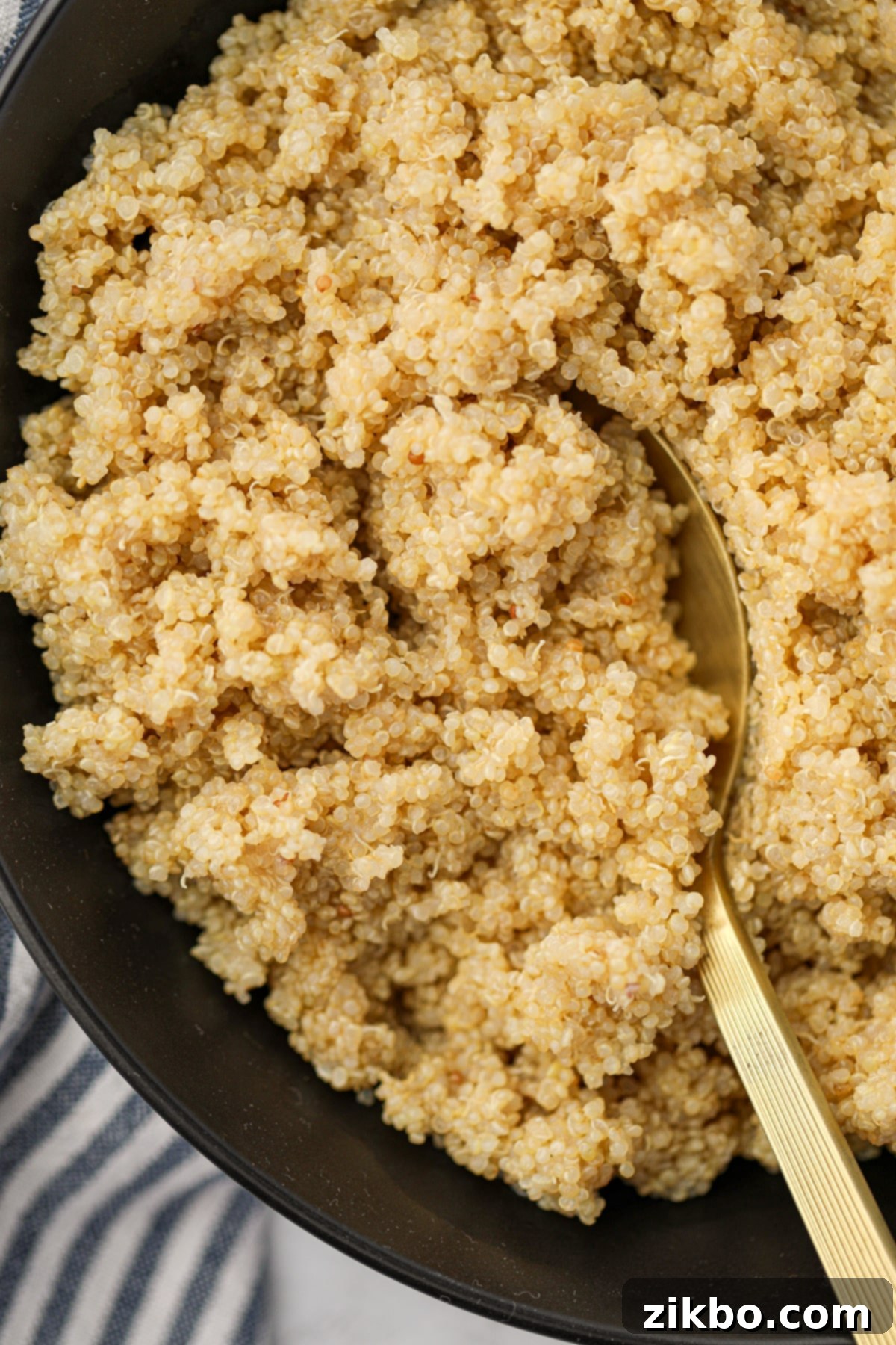 Perfect Fluffy Instant Pot Quinoa 2 Scooping quinoa from a black bowl.