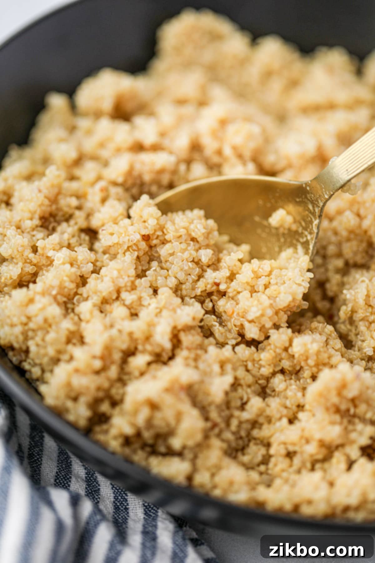 Perfect Fluffy Instant Pot Quinoa 8 A close up of cooked quinoa on a golden spoon.