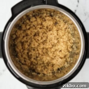 Perfect Fluffy Instant Pot Quinoa 9 An Instant Pot with cooked quinoa in the insert.