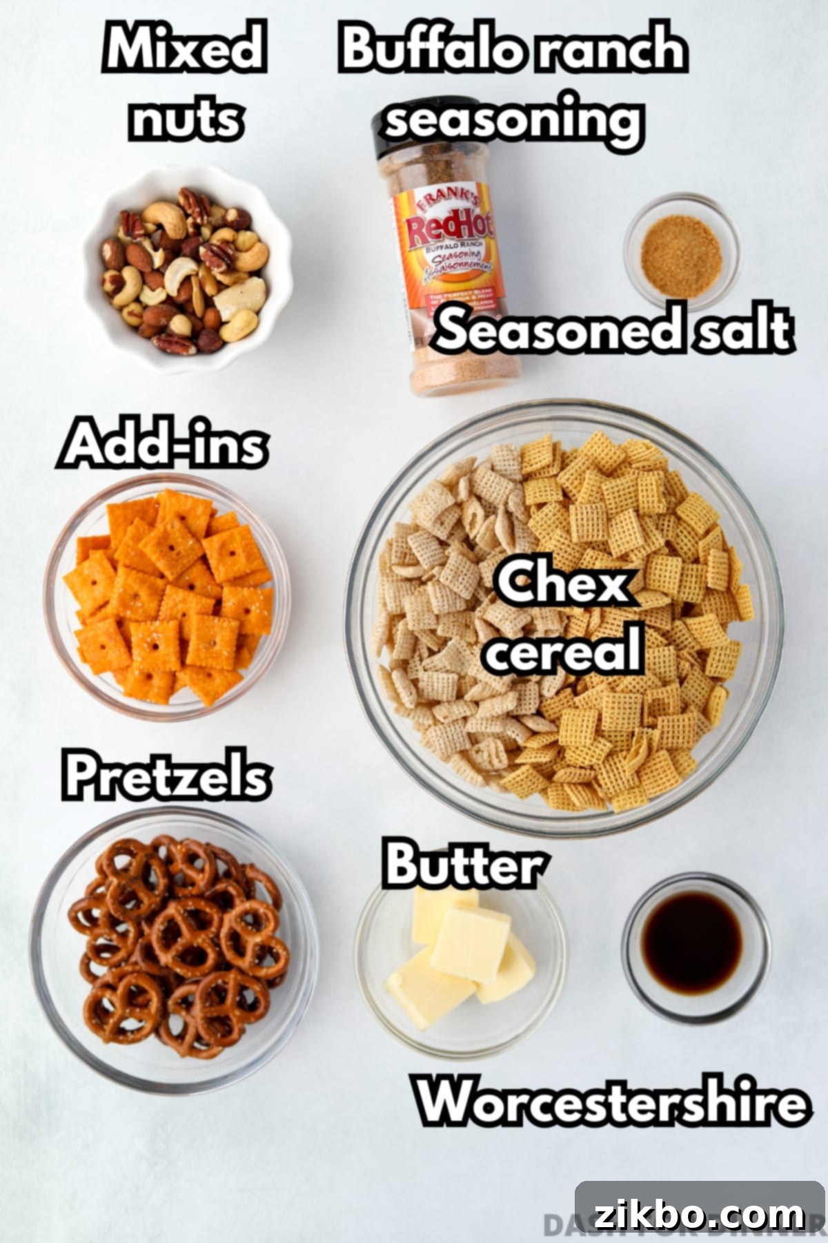 The ingredients needed to make spicy chex mix, including Chex cereal, pretzels, nuts, and various seasonings.