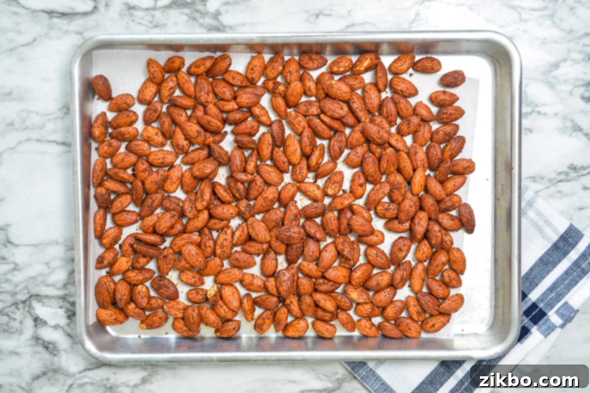 A sheet pan of air fryer roasted almonds, cooling down after being cooked.