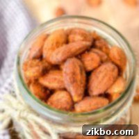 A jar of homemade roasted almonds, perfectly seasoned and crispy.