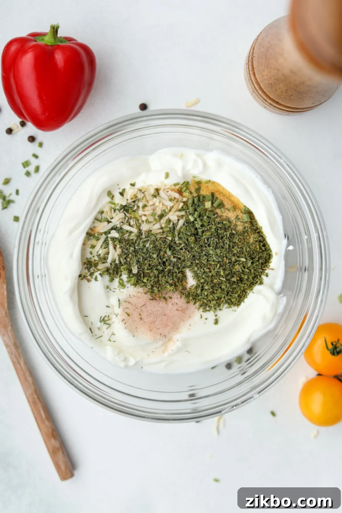 Zesty Greek Ranch Duo 4 A bowl of plain Greek yogurt with all the dried ranch seasonings added on top, precisely measured and ready for mixing.