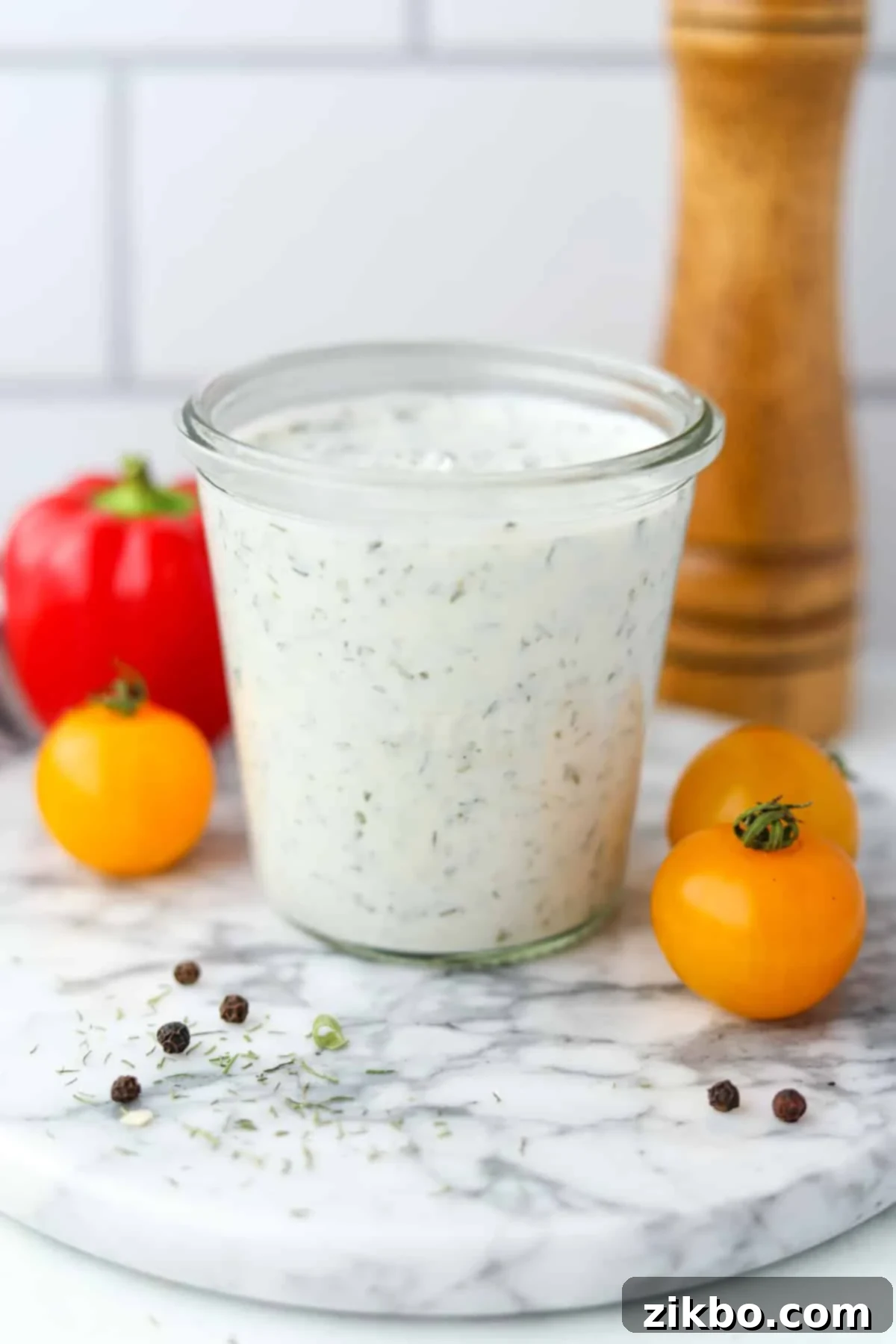 Zesty Greek Ranch Duo 7 A clear glass jar filled with freshly made Greek Yogurt Ranch, presented with an inviting backdrop of fresh vegetables, ready for dipping and enjoying.