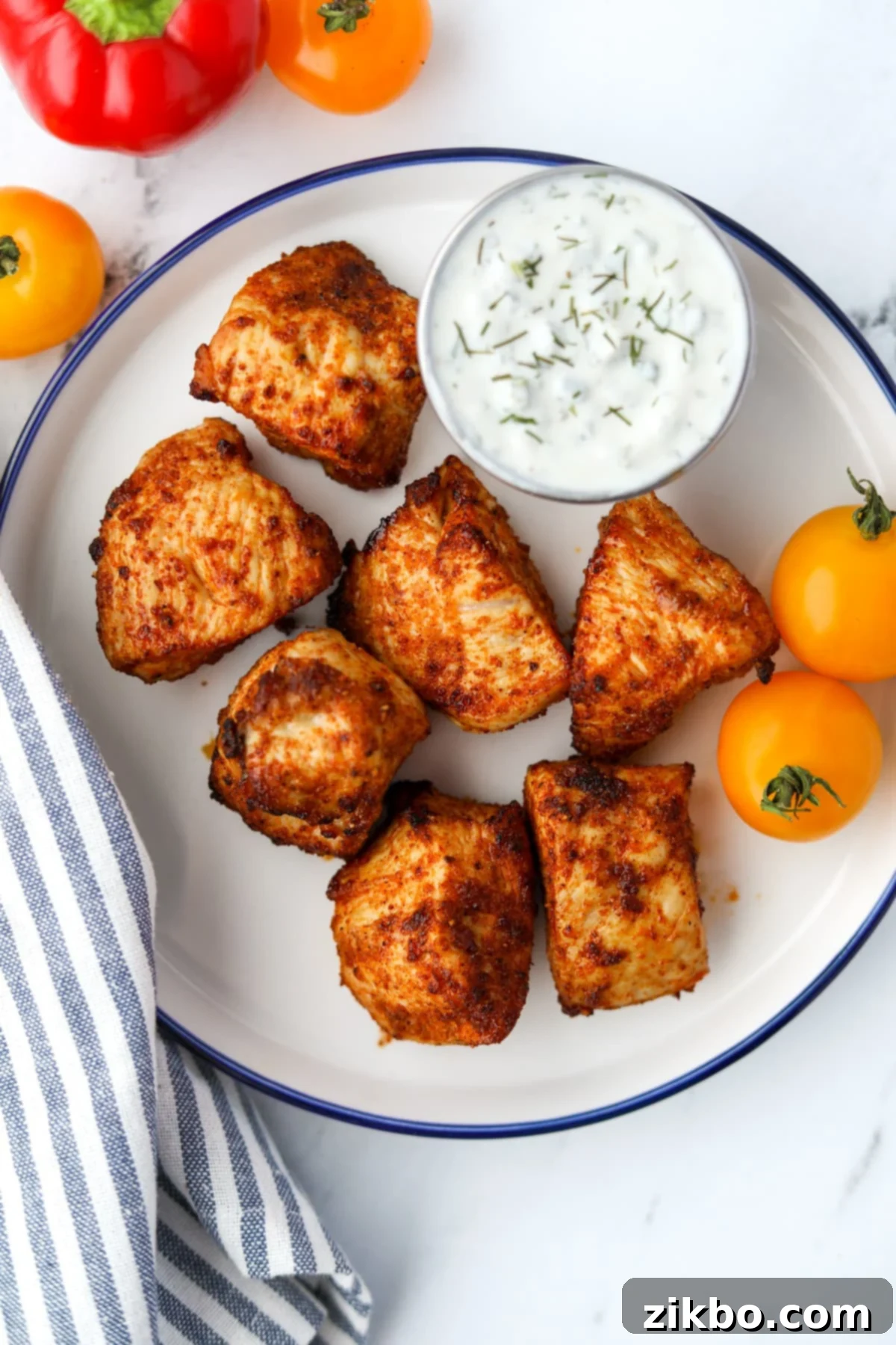 A plate with unbreaded chicken nuggets and a side serving of ranch dressing.