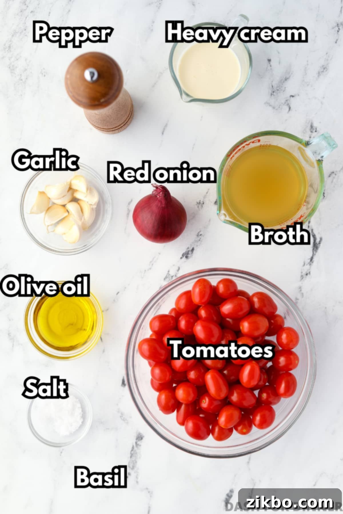 The ingredients needed to make tomato soup, including cherry tomatoes, broth, olive oil, and heavy cream.