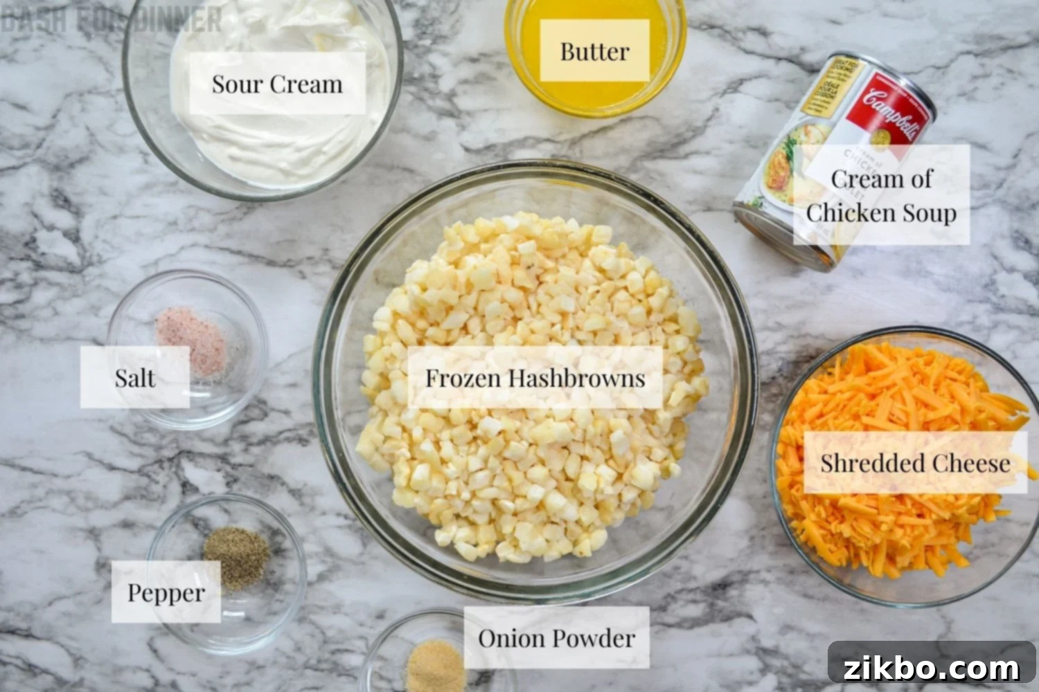Slow Cooker Golden Cheesy Hash Brown Casserole 3 A flat lay of all the essential ingredients needed to prepare a delicious slow cooker cheesy hash brown casserole, including frozen hash browns, sour cream, cream of chicken soup, cheese, and cornflakes.
