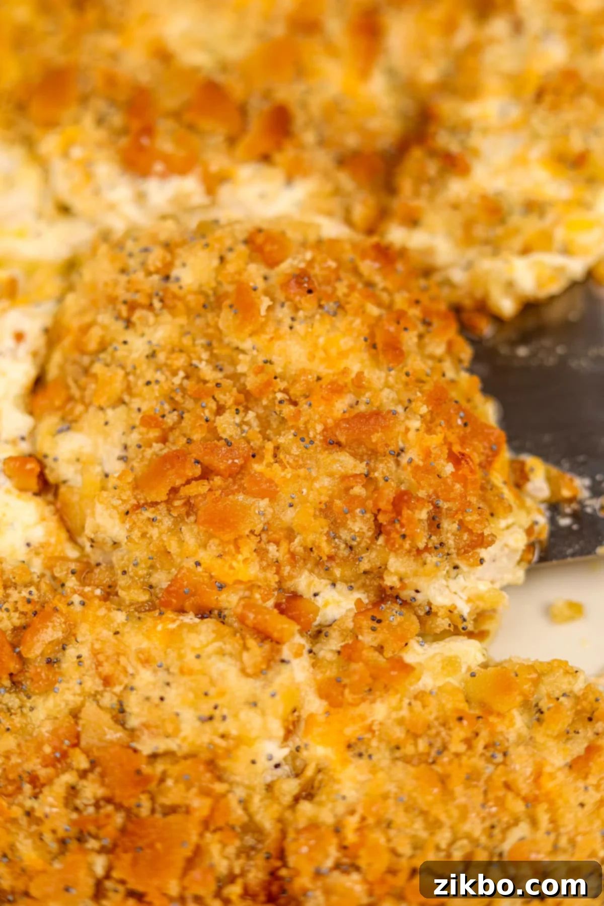 A close up of a cream casserole topped with a crispy cracker topping.