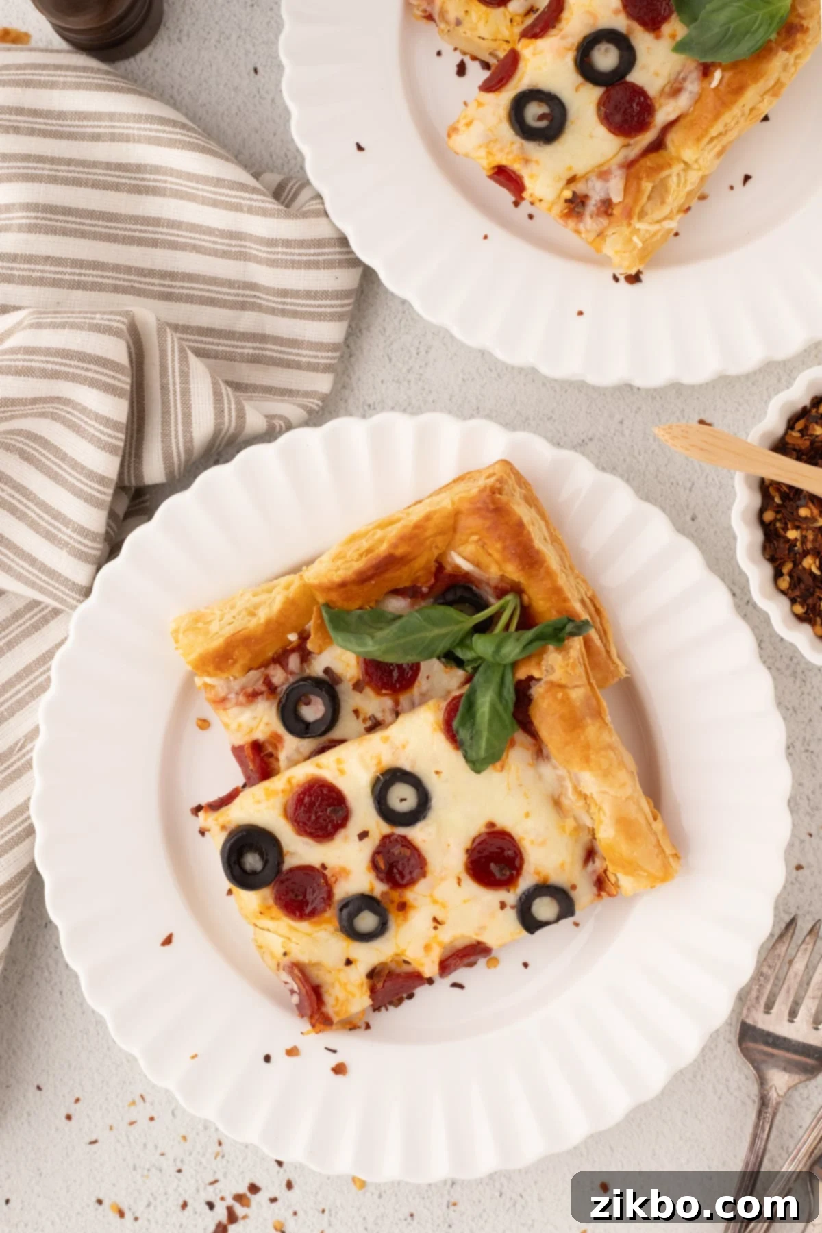 Golden Flaky Pizza Perfection 6 Close-up of a puff pastry pizza slice adorned with classic pepperoni and fresh basil, inviting you to take a bite.