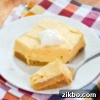 A fork with a portion of no bake pumpkin cheesecake bars.