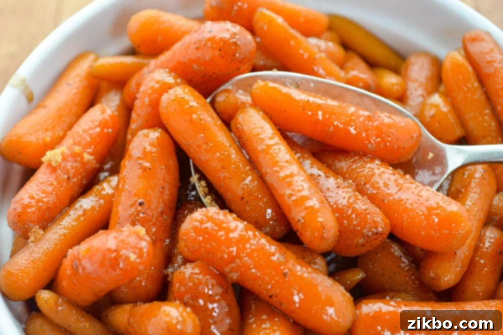 A baking dish filled with glazed baby carrots, sprinkled with brown sugar.