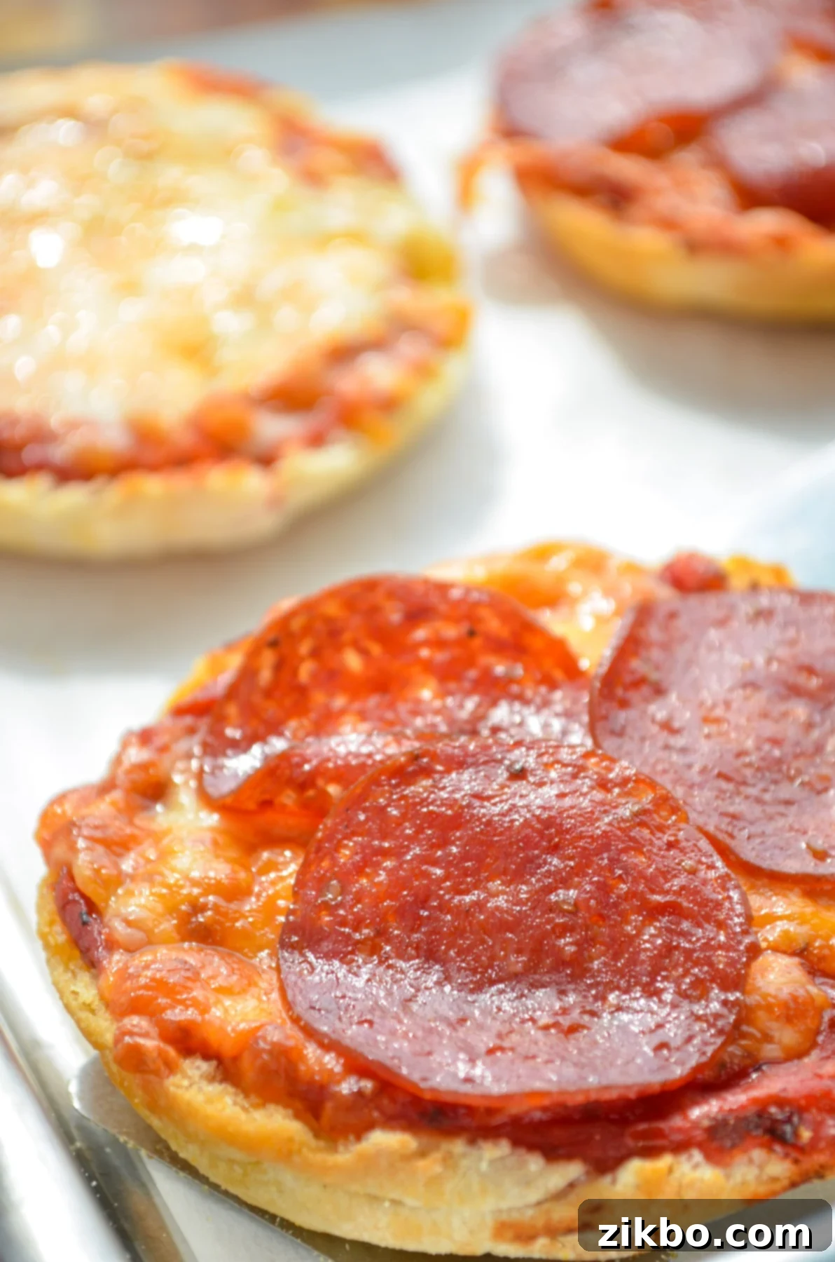 Freshly cooked air fryer English muffin pizzas, ready to eat.