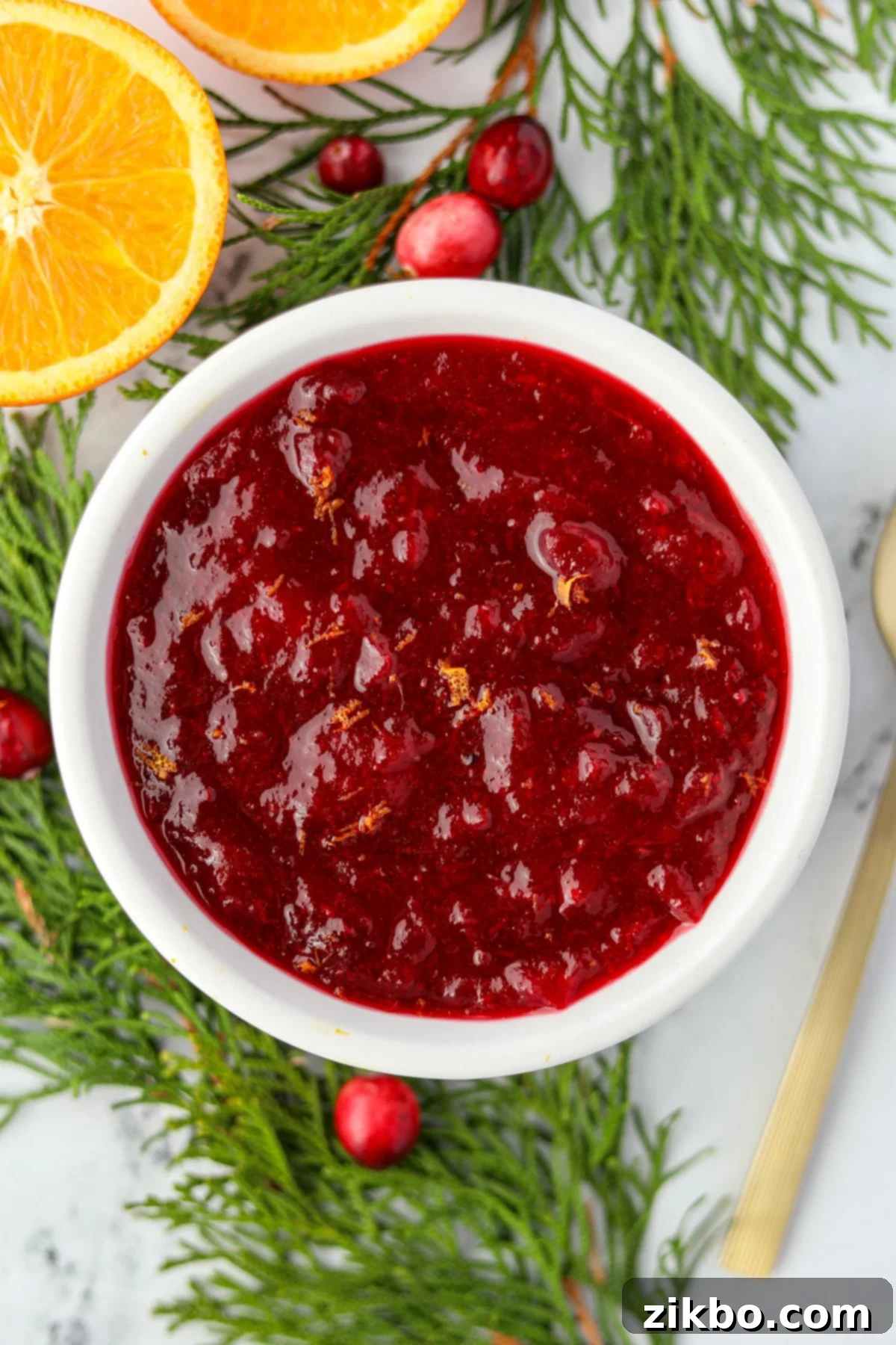 Cranberry Sauce From Scratch 2 A small bowl of cranberry sauce, garnished with orange zest.
